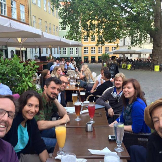 Group of songwriters from the copenhagen retreat looking towards the camera at lunch.